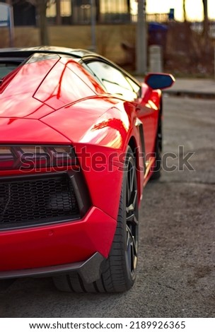 Showing a detailed rear section of a red exotic car.  Royalty-Free Stock Photo #2189926365