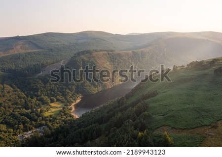 Aerial view of lakes located in Glendalough Valley (Irish: Gleann Dá Loch meaning valley of two lakes) in Wicklow Mountains in Ireland. Picture taken at sunset during a short but hot Irish summer
