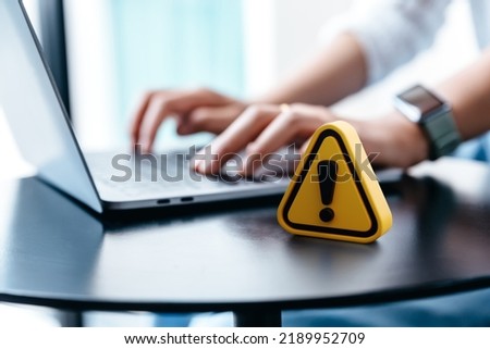 Warning sign on  table while businesswoman work, Network security, Dangerous information alert and incorrect data connection password concept. Royalty-Free Stock Photo #2189952709