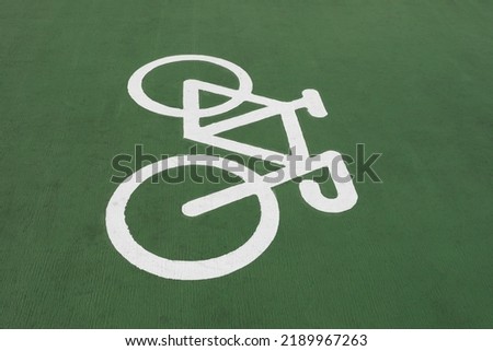 A bicycle symbol on green floor. Bike lane sign.