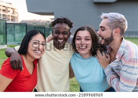 Young diverse group of friends having fun outside - Happy gen z people hugging outdoor - Focus on curvy girl face Royalty-Free Stock Photo #2189968969