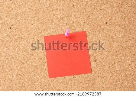 Office information board with attached blue sheet of paper with space for text.