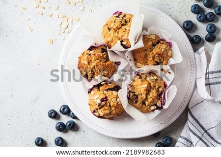 Vegan oatmeal, banana, blueberry muffins on a gray background, top view. Plant based dessert. Royalty-Free Stock Photo #2189982683