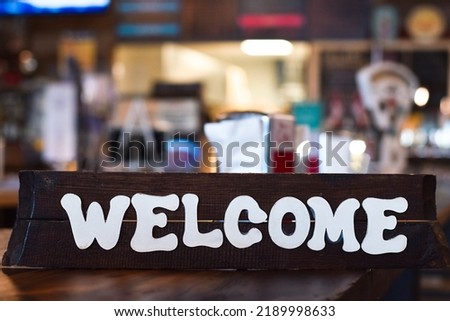 Wooden welcome sign in a restaurant or diner