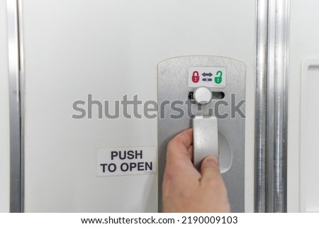 Door Lock button for Toilet on the plane. close up Royalty-Free Stock Photo #2190009103