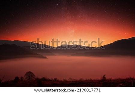 Mountains before dawn. Dawns in the sky and fog in the valley. Wonderful mountain summer landscape. Natural background.