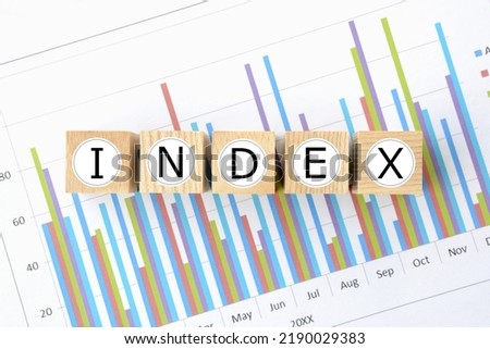 Wooden blocks with "INDEX" word on business chart background