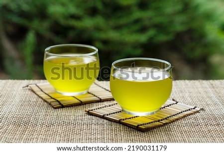 Cold Japanese green tea placed where you can see the garden. Japanese summer drink. Royalty-Free Stock Photo #2190031179