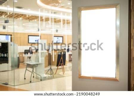 Billboard mockup a white sign on a pedestrian walkway inside an office building with a clipping path on screen. - Can be used to display products or to promote sales.