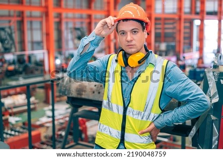 Portrait smart professional caucasian Industrial, factory engineer,technician,worker man stand confidence with safety helmet in steel metal sheet production, manufacture worker concept with copy space