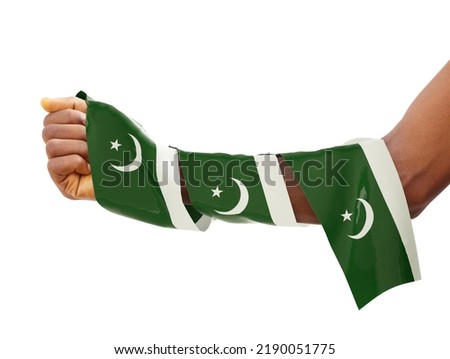 Hand wrapped in Pakistani flag. fist with 3d rendered flag isolated on white background