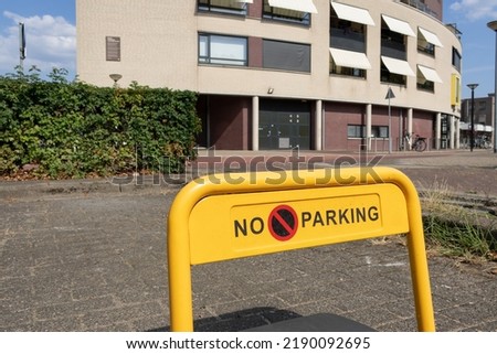 A yellow parking barrier with "no parking" written on it. Near the city centre of Oss (North Brabant, the Netherlands).