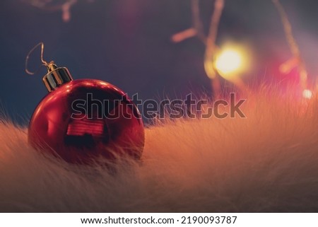 Red Ball Christmas Ornament on a Blue Background. Christmas Light Bulbs. Merry Christmas.