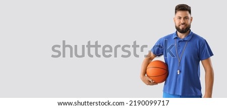 Portrait of male PE teacher on light background with space for text