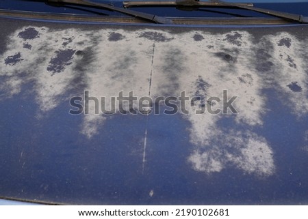 blue car hood with worn worn paint faded by the sun and age Royalty-Free Stock Photo #2190102681