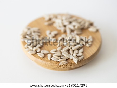 Hulled sunflower seeds on white background.