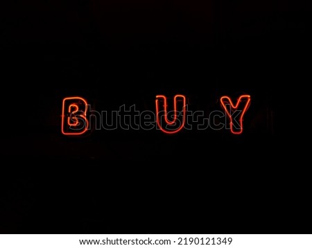 Electric sign "Buy" on a dark background