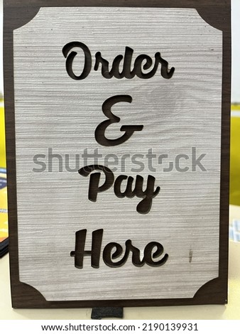a signboard where payment is displayed as a decoration for a place to eat Royalty-Free Stock Photo #2190139931