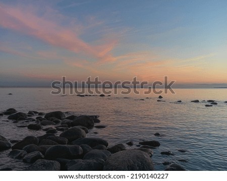 Rocks on the sunset lights in Finnish bay