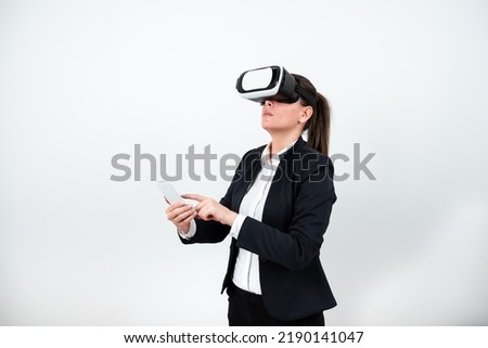 Woman Having Vr Glasses, Holding Mobile Phone And Pointing On It With One Finger. Businesswoman Having Virtual Reality Eyeglasses, Cellphone And Presenting New Idea