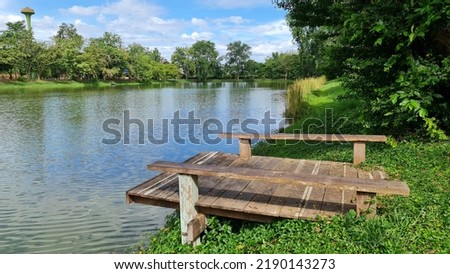 Sitting by the water, is a wooden floor extending above the water surface. to relax in the cool breeze