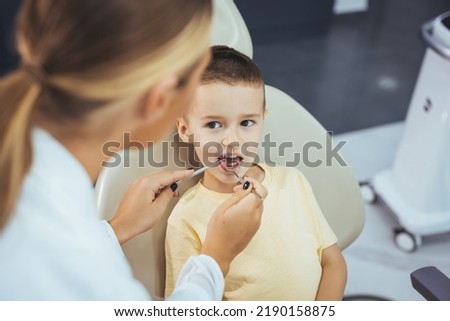 Beautiful boy at the dentist getting a check up on her teeth - pediatrics dental care concepts. Cute little boy getting teeth exam at dental clinic. Dental care, Medical care, Lifestyle, Dental clinic
