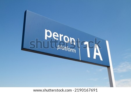 Blue railway station sign in Poland. Train platform number information. Letters in Polish language, peron means platform.