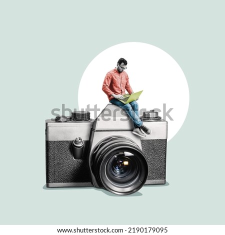 A man with a laptop is sitting on the photo camera.