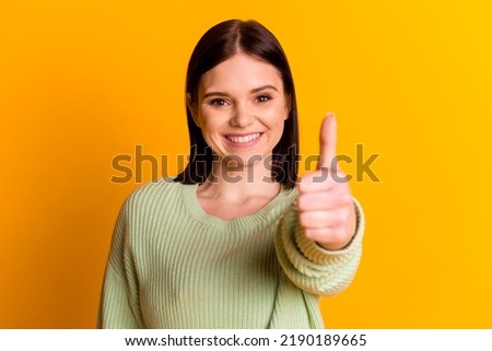 Photo of young cheerful girl show thumb-up approve good job ideal isolated over yellow color background.