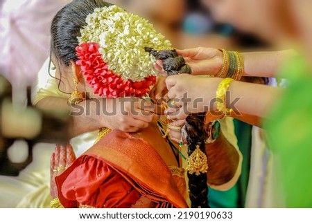 Groom tie a Thali Tali knot to the Bride to take care of her for the entire life Traditional Kerala Hindu Wedding Knot popularly known as Thali Tali It is a union of two individuals as spouses Royalty-Free Stock Photo #2190190633