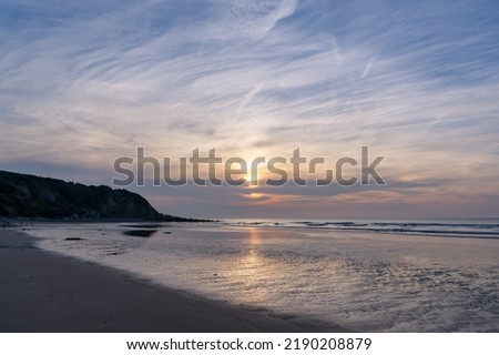 Colorful sunset at Cap Gris Nez (France) in summer, calm sea