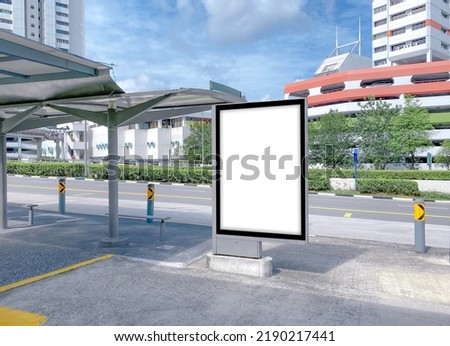 Vertical advertising poster mockup at empty bus stop shelter by main road. Out-of-home OOH 6 sheet billboard media display space in city