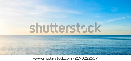 The view of the sea in the morning with the golden rays of the sun shining on the sea in summer Royalty-Free Stock Photo #2190222557