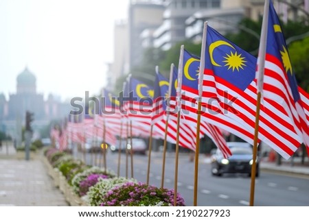 The Malaysia flag is also known as Jalur Gemilang waving with a city in the background. Independence Day or Merdeka Day celebration on 31 August and Hari Malaysia on 16 September, copy space concept. Royalty-Free Stock Photo #2190227923