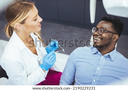 A perfect result of a dentist’s work which is seen in the beautiful and white smile on a patient who is absolutely satisfied with a result of a treatment given in a clinic. Man having teeth examined 