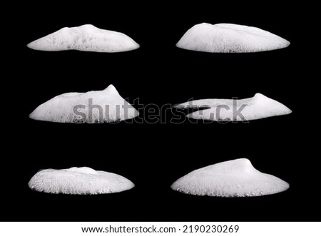 Set liquid white foam from soap or shampoo or shower gel. Abstract bubbles. isolated on a black background  Royalty-Free Stock Photo #2190230269