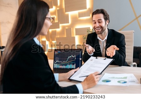 Cooperation concept. Business woman, company director, hiring specialist in a trading company, sits at a desk in front of a laptop, conducts a hiring interview, focused studying candidate's resume Royalty-Free Stock Photo #2190233243