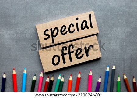 special offer wooden blocks with text near colorful pencils. pencils point to text