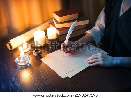 Close up top view past god biblical law mail notice page pray read space. Closeup age male arm hold nib inkwell scribe draw art diary teach notepad card author human man boy dark black wood desk table Royalty-Free Stock Photo #2190249195