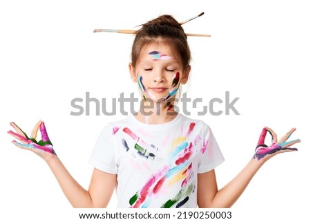 child girl with hands painted in colorful paint make heart shape