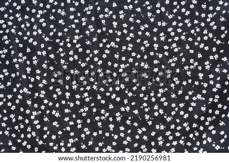 Vintage floral background. Floral pattern with small white flowers on a black background.  Royalty-Free Stock Photo #2190256981