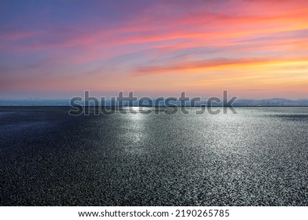 Asphalt road ground with colorful sky clouds at sunset. high angle view. Royalty-Free Stock Photo #2190265785