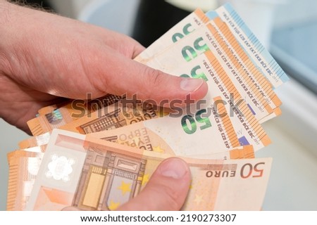 Counting money for a rent. Saving money concept. Finance, business, investment. Keeping savings at home. Spending cash for unexpected expense, unplanned losses, real estate, debts, taxes.
 Royalty-Free Stock Photo #2190273307
