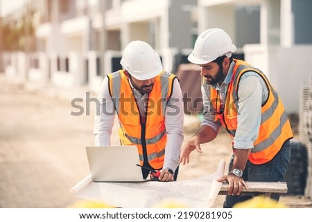 Two Caucasian man Construction engineers and architects working together at construction site using laptop and blueprints on table. Real estate work site project. Royalty-Free Stock Photo #2190281905