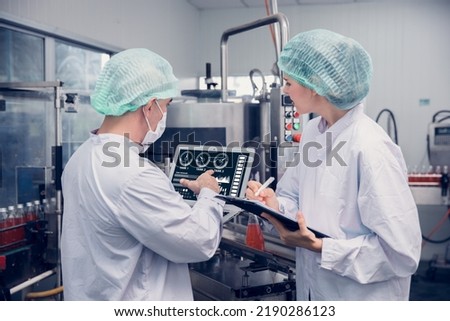 Food and Drink factory worker working together with hygiene monitor control mix ingredients machine with laptop computer Royalty-Free Stock Photo #2190286123