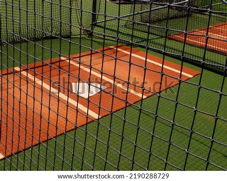 Baseball practice area fence with home plate for warm up pitching Royalty-Free Stock Photo #2190288729