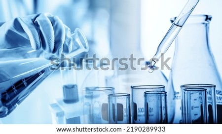 hand of scientist holding flask with lab glassware in chemical laboratory background, science laboratory research and development concept	 Royalty-Free Stock Photo #2190289933