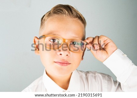 a cheerful guy in glasses holds on to them