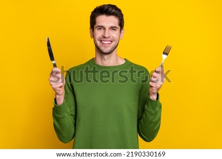 Photo of charming excited young guy wear green sweater ready eating tasty dinner isolated yellow color background Royalty-Free Stock Photo #2190330169