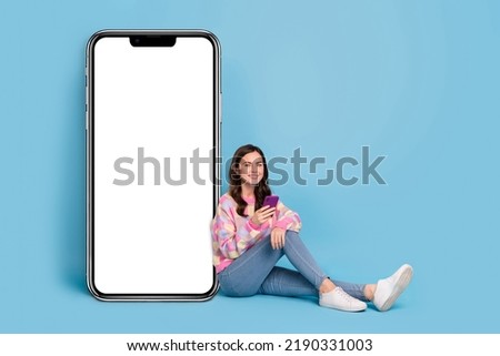 Full size photo of young pretty girl use mobile download share speed connection 4g isolated over blue color background